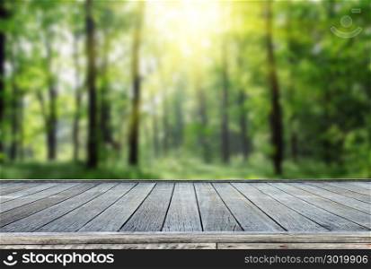 wooden deck table with forest background