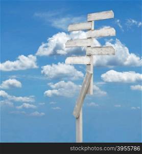 wooden direction sign with blank spaces for text on beautiful sky background