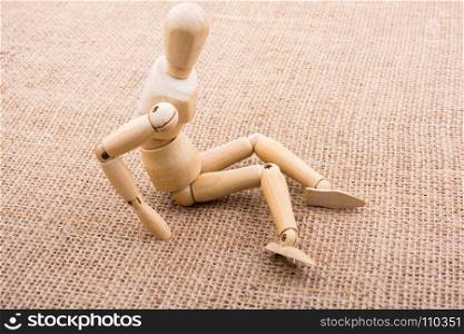 Wooden dolls of a man posing on canvas