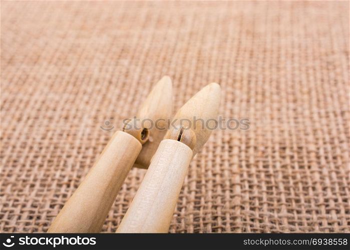 Wooden dolls posing with his legs on canvas