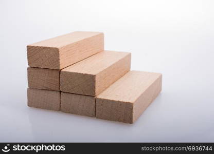 Wooden Domino Blocks in a line on a white background