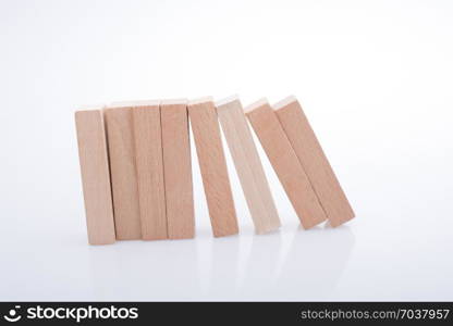 Wooden Domino Blocks in a line on a white background