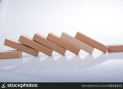 Wooden domino blocks on white background. Wooden Domino Blocks in a line on a white background