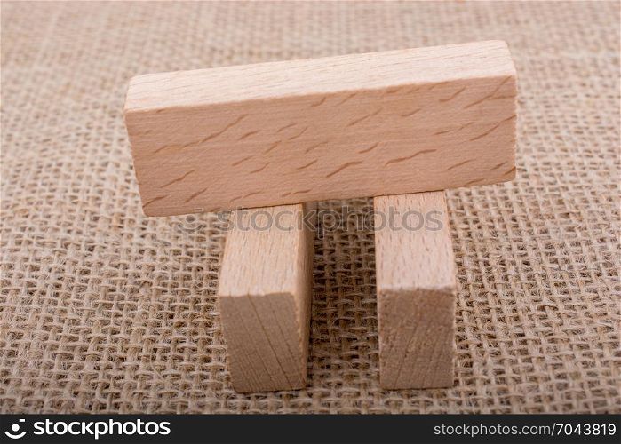 Wooden domino on a linen canvas background