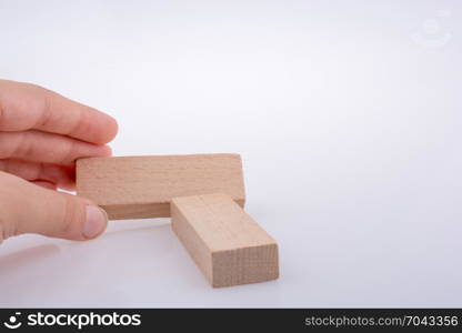 Wooden domino pieces positioned on white background