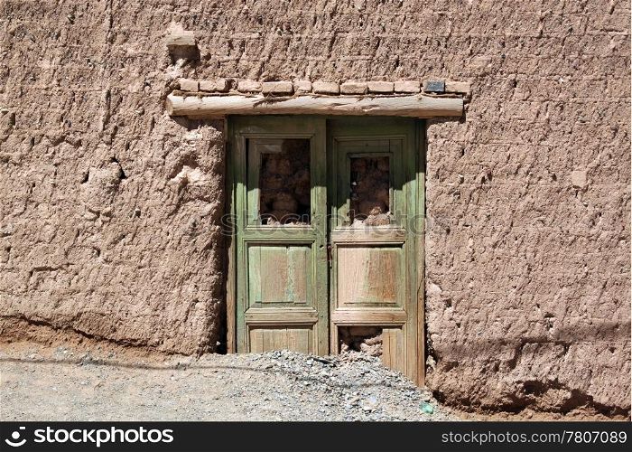 Wooden door and brick wall of house