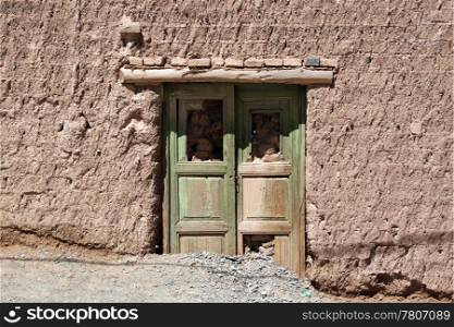 Wooden door and brick wall of house