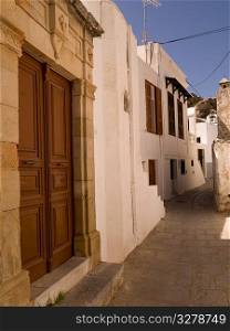 Wooden door and stone wall in Rhodes Greece