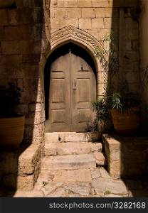 Wooden door and stone wall in Rhodes Greece