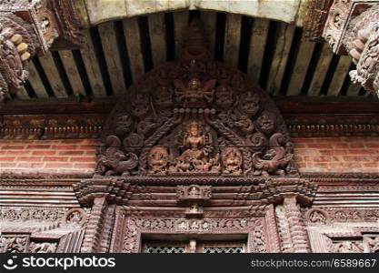 Wooden door and wall of temple in Bhaktapur, Nepal
