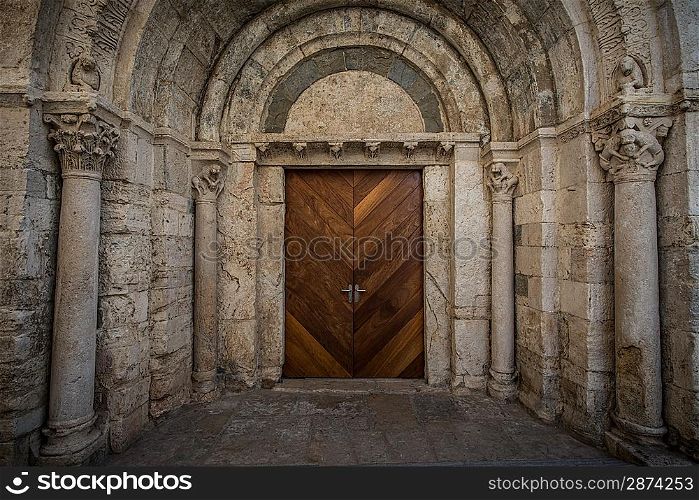 Wooden door in ancient archway
