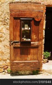 Wooden door of a house, Monteriggioni, Siena Province, Tuscany, Italy