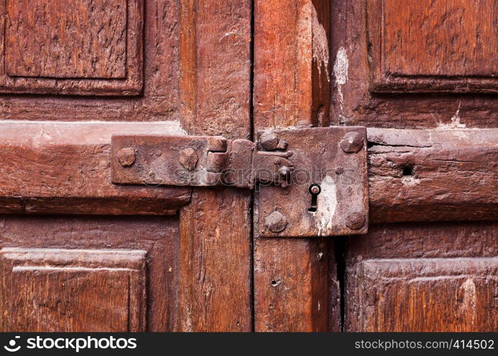 wooden door with a keyhole and latch