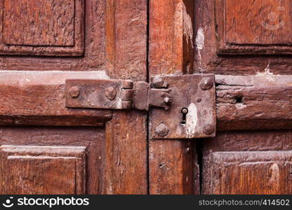 wooden door with a keyhole and latch