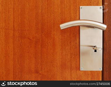 wooden door with metallic door handle with key