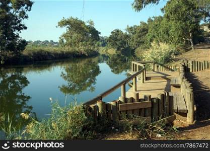 Wooden embankment on the river in Nahal Alexander national park in Israel
