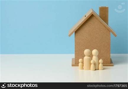 wooden family figurines, model house. Real estate purchase, rental concept. Moving to new apartments, copy space