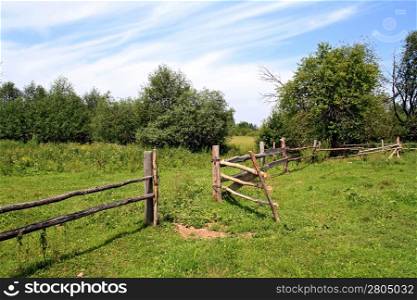 wooden fence on green pasture