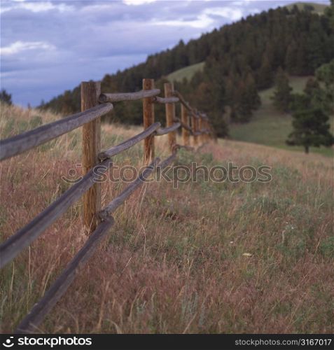 Wooden fence on hill