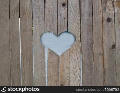Wooden fence with heart, close up, detail, copy space