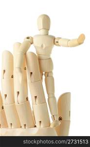 wooden figure of little man standing on big hand and pointing at right, front view, isolated on white