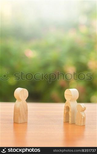 Wooden figures of a mother with a child stands apart from the father. Deprivation of parental rights. The child stay with the mother. Conflict resolution in court. Protection of mother s rights