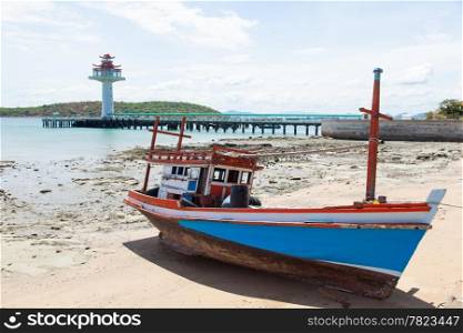 Wooden fishing boat moored on the beach. Fishing dock area of the island.