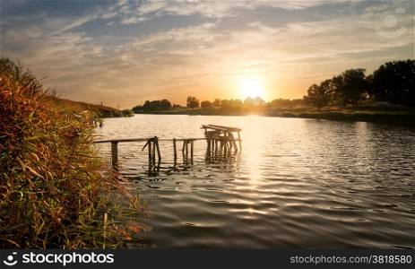 Wooden fishing sigean at sunset in autumn