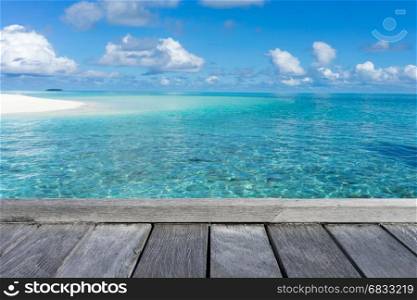 Wooden floor with seascape and blue sky background