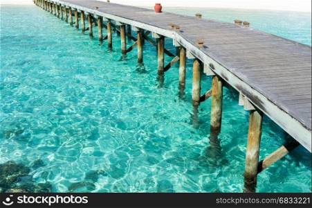 Wooden floor with seascape and blue sky background