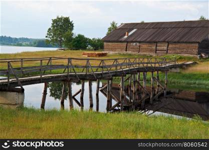 Wooden footbridge over pond.Kenozerye.Arkhangelsk region, Russia
