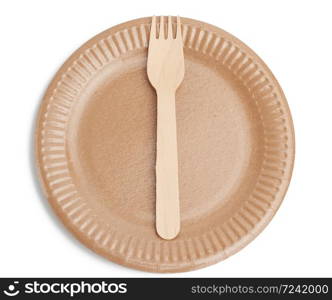wooden fork and empty round brown disposable plate made from recycled materials isolated on white background, top view. Concept of the absence of non-recyclable garbage, rejection of plastic