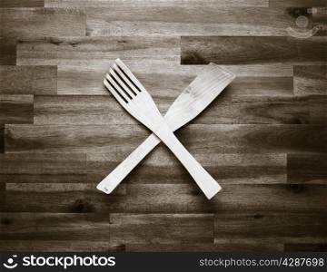 Wooden fork and spatula on the table - tinted black and white image
