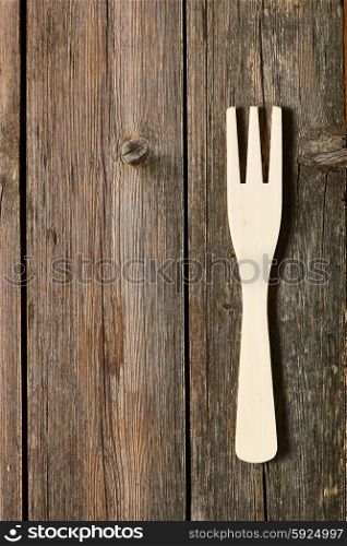 Wooden fork on rustic background