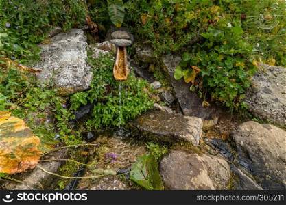 Wooden fountain on mountain Kackarlar, a mountain range that rises above the Black Sea coast in eastern Turkey,Rize. Wooden fountain on mountain Kackarlar in Turkey,Rize