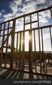 Wooden frame with sunburst in middle at construction site.