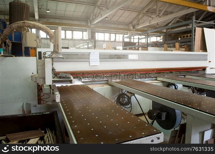 Wooden furniture production. Industrial cutting machine for automatic wood cutting. Wooden furniture production.