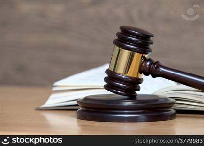 wooden gavel and books on wooden table