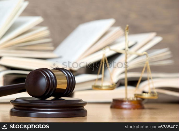 wooden gavel and books on wooden table