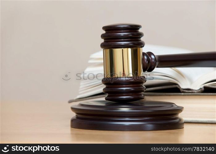 wooden gavel and books on wooden table