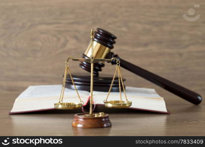 wooden gavel and books on wooden table