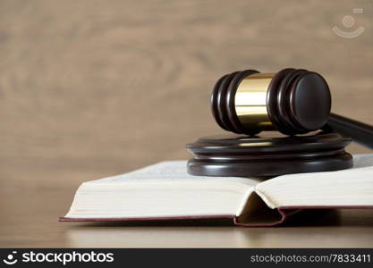 wooden gavel and books on wooden table