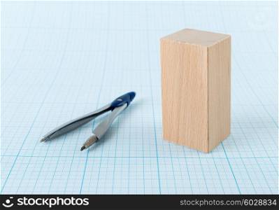 Wooden geometric shape parallelepiped on graph paper