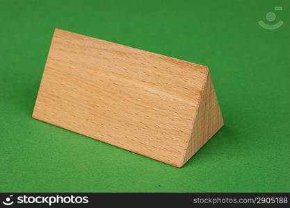 wooden geometric shapes on a green background