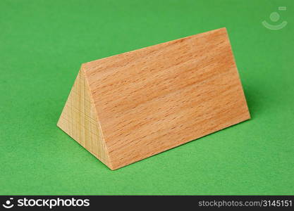 wooden geometric shapes on a green background