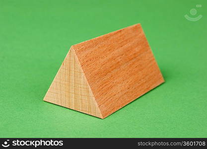 wooden geometric shapes on a green background