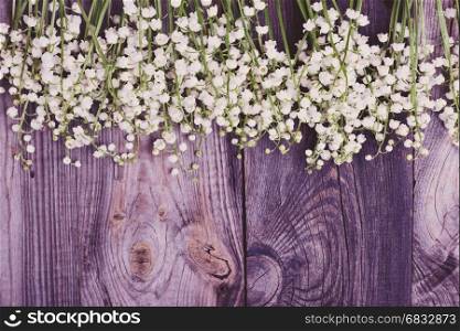 Wooden gray background with fresh flowers lilies of the valley, empty space