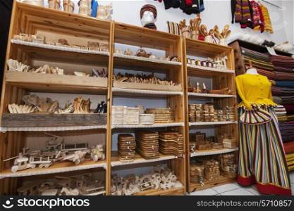 Wooden handicrafts displayed on shelves in gift store