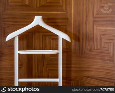 Wooden hanger stand on brown wooden background