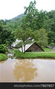 Wooden hause and pond in the forest in Northern Thailand
